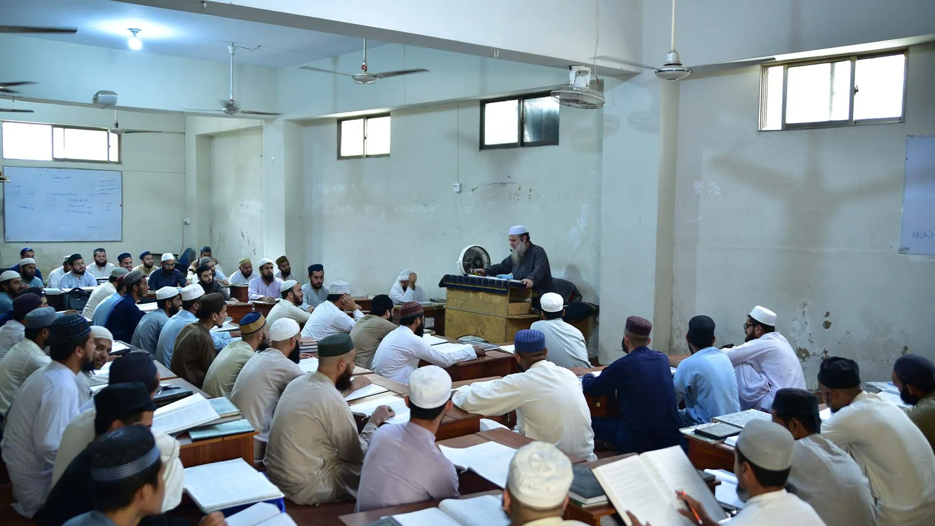 Teacher teaching students in a Jamia Binoria classroom